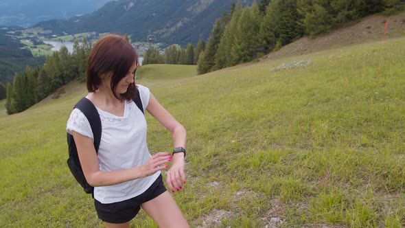 Female Hiker Using Smart Watch While Walking
