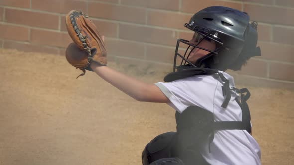 A boy plays catcher in a little league baseball game.