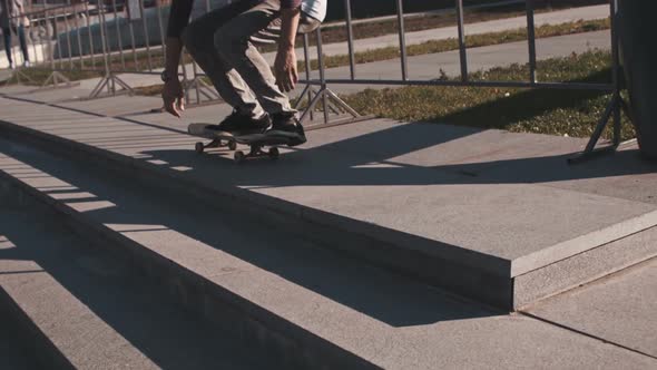 Young Man in Sportswear Balancing on Skateboard in Urban Environment