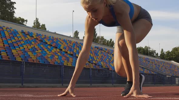 Self-Confident Woman Preparing to Run at Starting Line at Stadium, Slowmotion