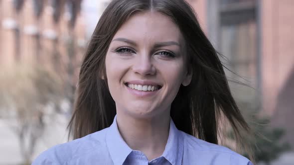 Portrait of Smiling Young Woman Looking at Camera