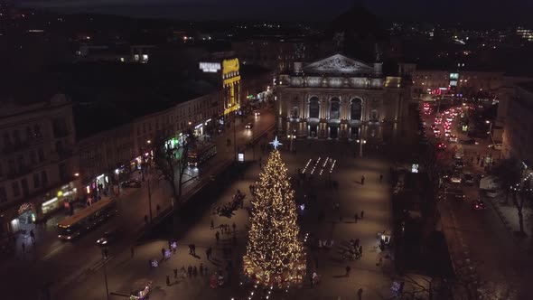 Arial View of Lviv Christmas Tree Near Opera House Festive Lights and Fair Market on Winter Night