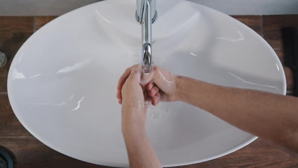 Closeup Male Hands Washing in Large White Sink at Home in Bathroom in Hotel Daily Hygiene Body Care