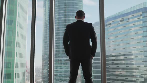 Hard Times for a Businessman and His Business. Thoughtful Businessman Portrait in His Office Near a