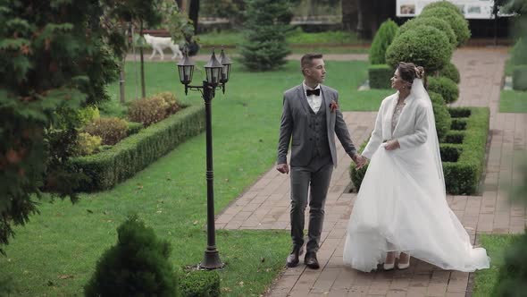 Lovely Newlyweds Caucasian Bride Groom Walking in Park Holding Hands Wedding Couple Family