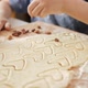 Closeup of Little Boy Filling Biscuit Dough with Raisins and Nuts - VideoHive Item for Sale