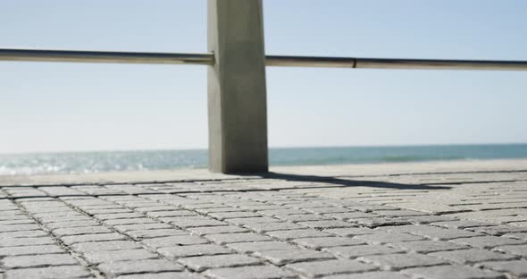 Fit couple jogging on a promenade at beach 4k