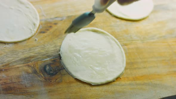 The Chef Greases the Round Tortilla Dough with Oil