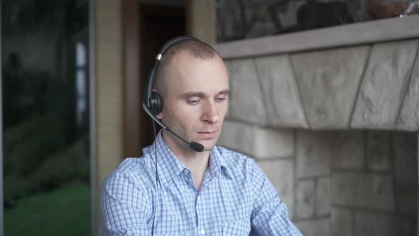 A Young Man Works at a Computer