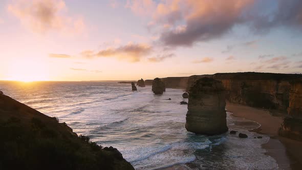 sun sets on the famous twelve apostles rock formations on the great ocean road