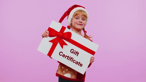 Funny Girl Wears Christmas Santa Hat and Hat Presenting Card Gift Certificate Coupon Winner Voucher