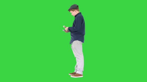 Stylish Teenager Boy Counting Euros on a Green Screen Chroma Key