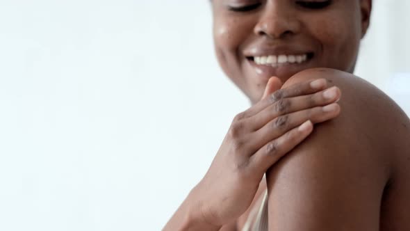 Black African American Girl Applying Moisturizing Cream on a Shoulder Lady Apply Cream on Skin and