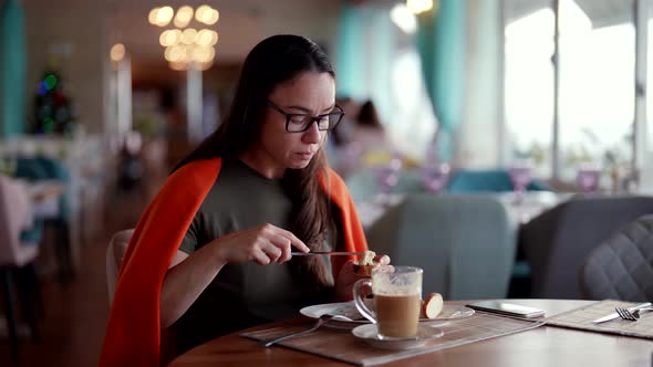 Coffee Break in Restaurant Adult Woman is Eating Alone Latte and Cake or Sandwich for Lunch
