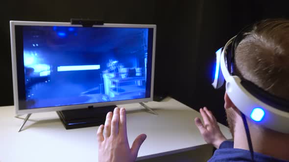 Man Virtual Reality Helmet Look Closeup Computer Game Room While Help with Hand