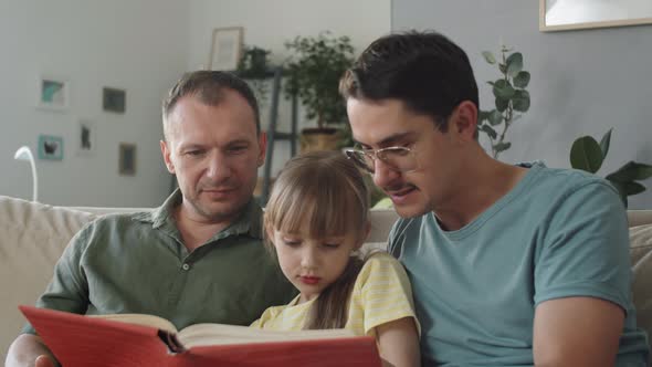 Parents And Kid Reading Book