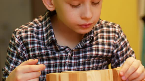 Boy builds a tower from blocks game.