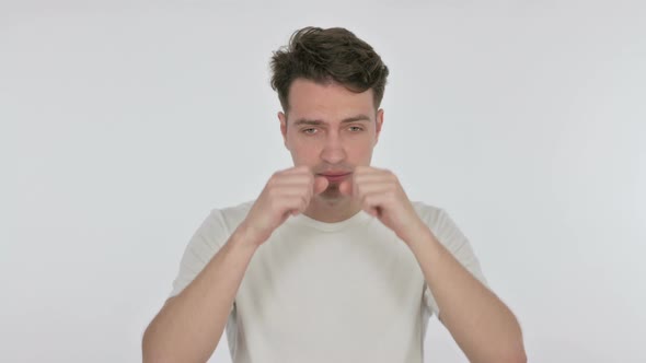 Tired Young Man Rubbing Eyes on White Background