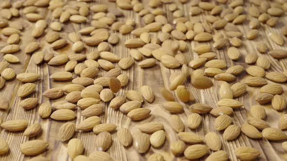 Dried Almond Lying on a Textured Wooden Table Surface