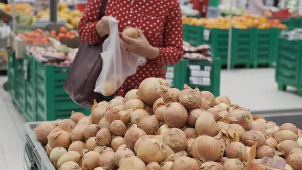 Senior Woman Choosing Onions in a Grocery