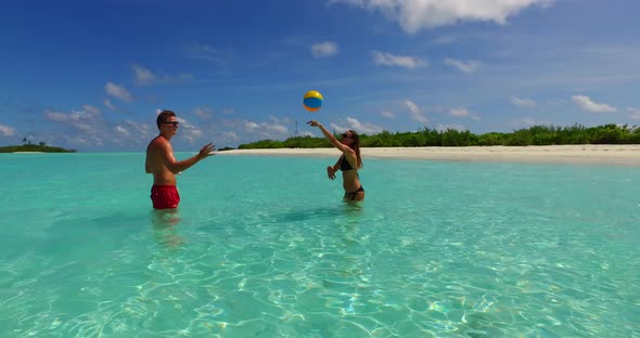 Young man and woman married on vacation live the dream on beach on sunny white sandy  background