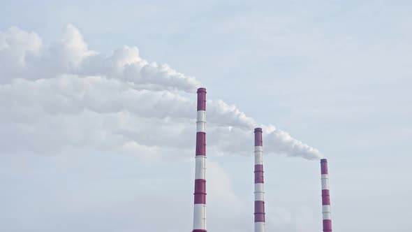White Smoke From the Chimneys of a Thermal Power Plant Against a Blue Sky