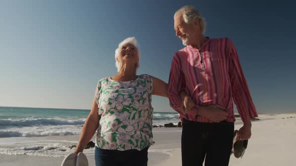 Senior couple walking together at the beach