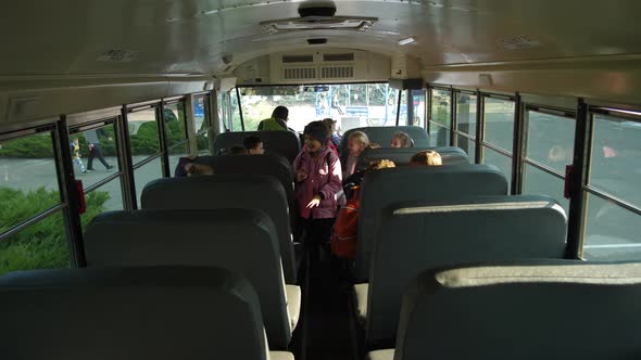 Happy Kids Taking Places in School Bus To Go Home