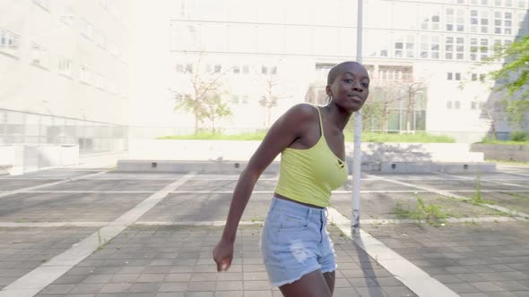 Slow motion shot of young woman dancing in city