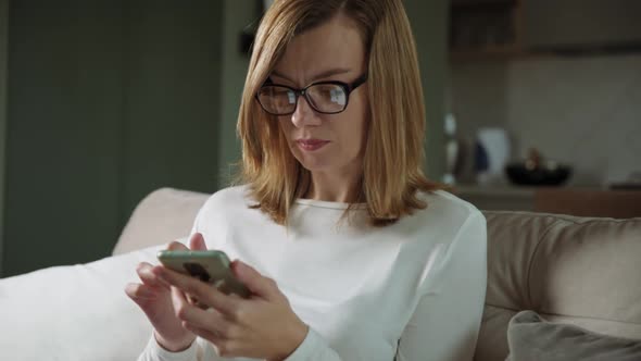 Woman Using Smartphone at Living Room