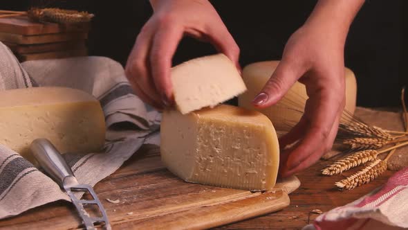 Women hands take away pieces of fresh homemade cheese close up