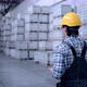 Worker Male Warehouse Worker Engineer Man in a Helmet Working on the Construction Site of the - VideoHive Item for Sale