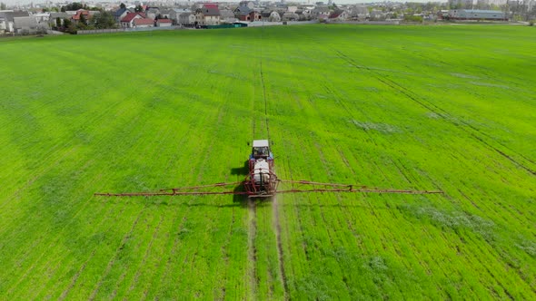 Tractor Sprayer Works in the Field.