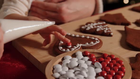 Mother and Daughter Decorating Gingerbread at Home