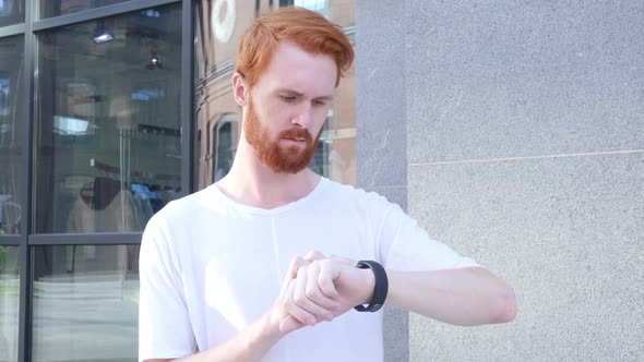 Beard Man Using Smartwatch