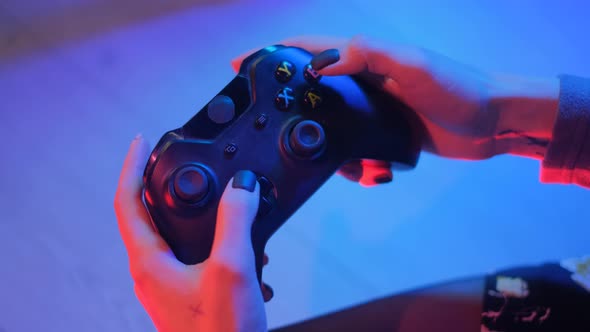 Controller in the Hands of Gamer. Young Girl Is Playing a Computer Games at