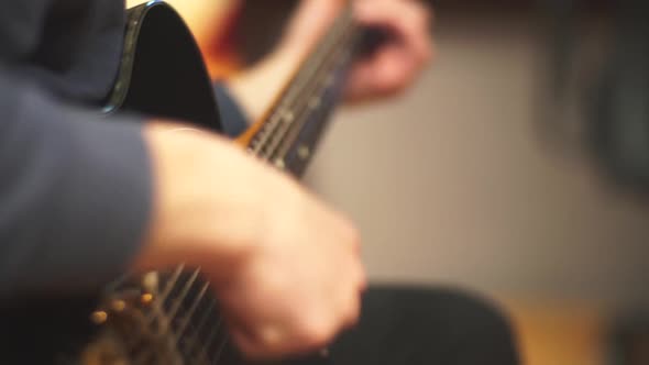 Close-up of man playing electric guitar