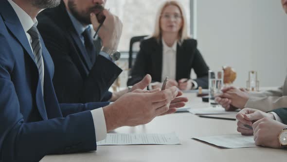 Businessmen with Lawyers Having Meeting in Office