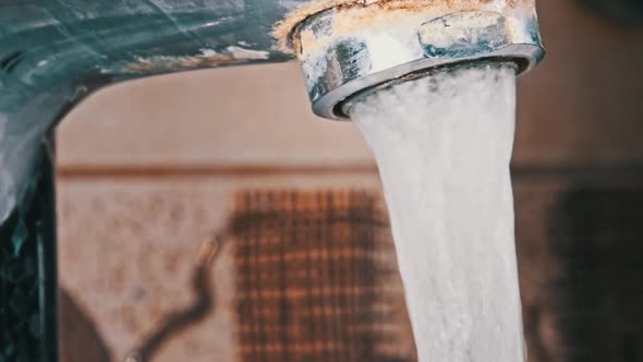 Faucet with Running Water in Slow Motion Macro Shot