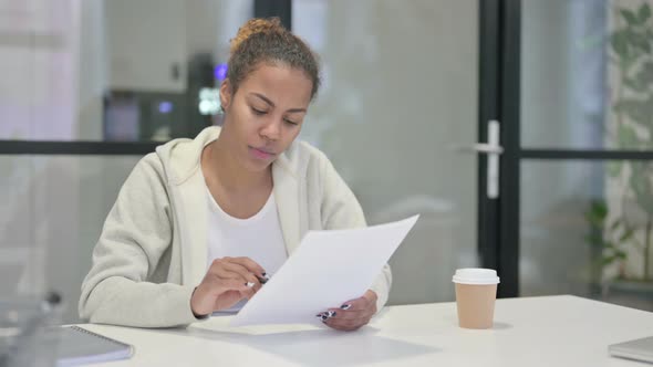 African Woman Having Success While Reading Reports