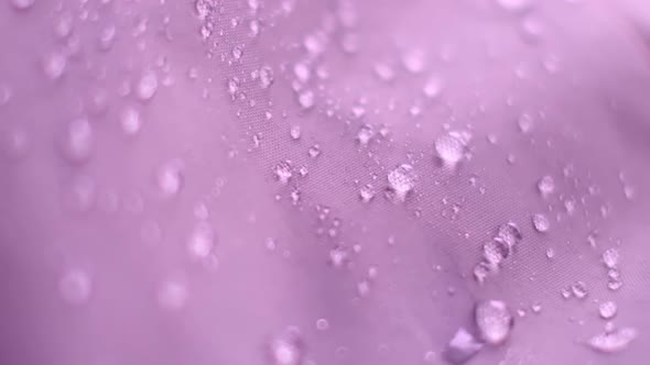 Slow Motion Shot of Water Splashing on Waterproof Fabric