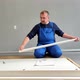 A Man a Handyman in a Blue Jumpsuit is Assembling a Table in Closeup - VideoHive Item for Sale