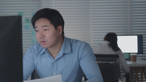 Concentrated Businessman looking at paperwork checking and reviewing a business financial report