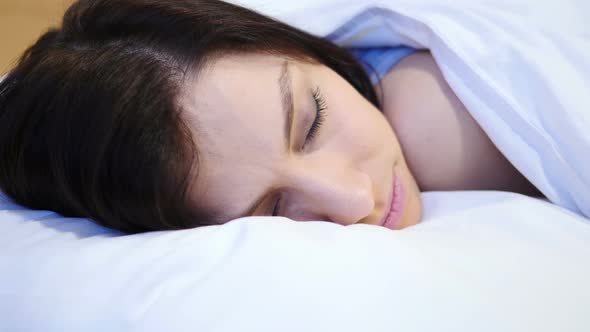 Close Up of Young Woman Sleeping in Bed at Night