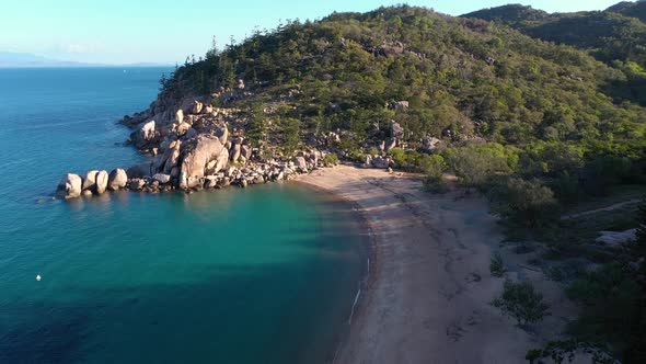 Magnetic Island Arthur Bay empty beach aerial with tree shadows and boulders, Queensland