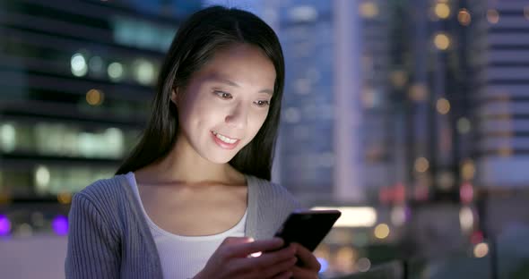 Woman read on smart phone in city