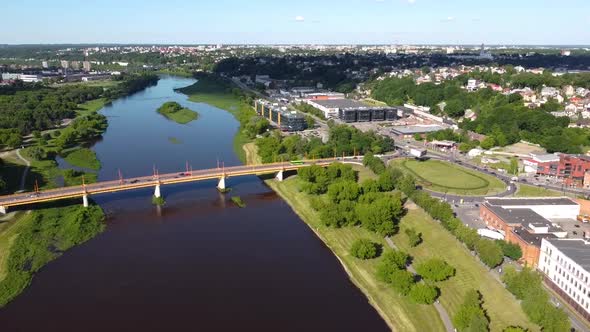 Kaunas, Lithuania. Aerial View of Bridge Traffic Above Neris River, Shopping Malls and Corporate Bui