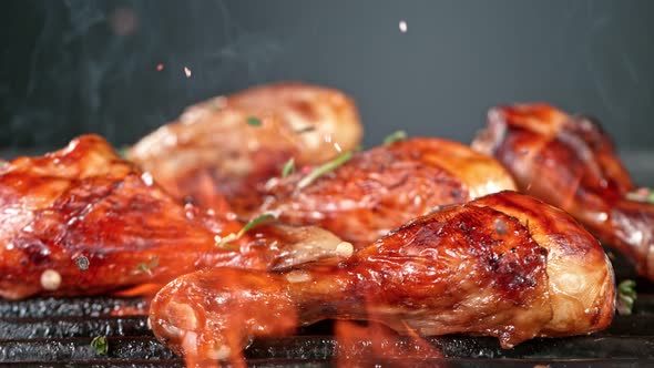 Super Slow Motion Shot of Seasoning Falling on Fresh Grilled Chicken Legs at 1000 Fps