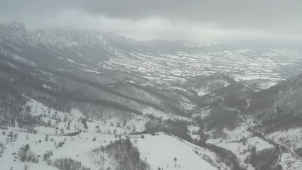 Snow falling over the mountain in Eastern Sebia 4K aerial video