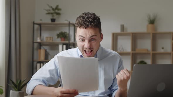 Attractive Young Guy Read Good News in Document